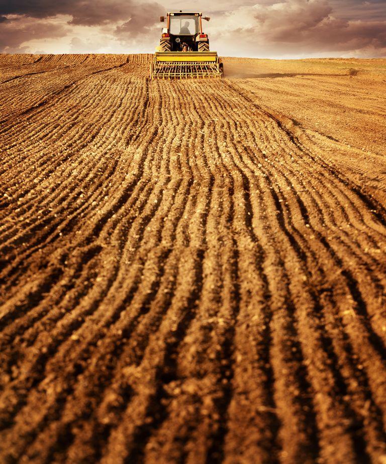 In-furrow application of seed row solutions during planting in agricultural field
